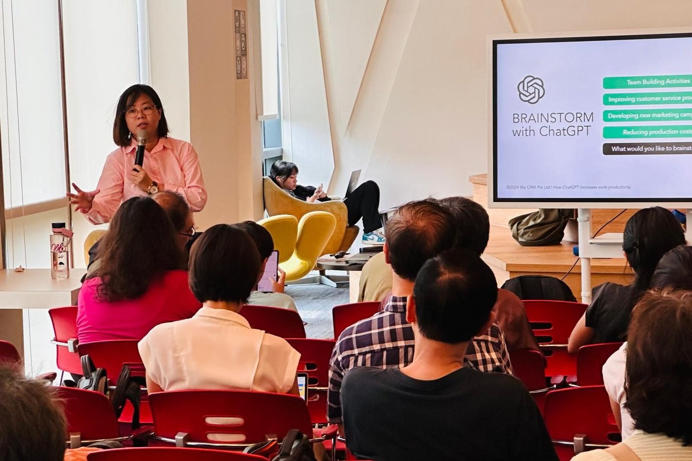Trainer presenting “Brainstorm with ChatGPT” to a workshop audience